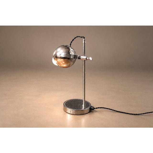 This pair of Brazilian modern table lamps from the 1960s distills industrial precision into a striking sculptural form....