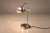 This pair of Brazilian modern table lamps from the 1960s distills industrial precision into a striking sculptural form....