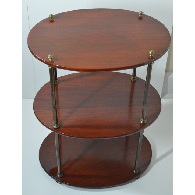 Mahogany Brass Three Tier Oval English Campaign Style Etagere Shelf Table. Beautiful warm wood on stacked brass column...