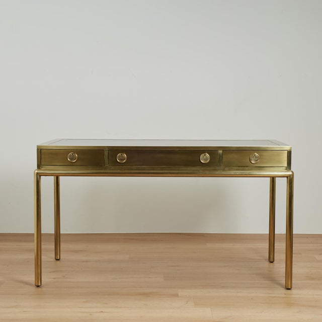 Chic mid century desk or bureau plat crafted in brass with a custom acid washed finish, featuring a tooled leather top on...