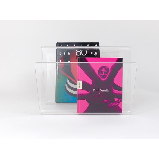 A stylish Italian transparent W-shaped post-modern magazine holder / newspaper stand with handle from the 1980s, made of...