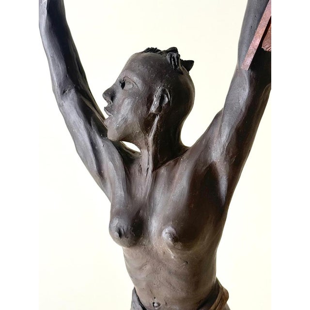 This exceptional hand-crafted studio ceramic sculpture depicts a proud and commanding African female warrior in a...