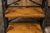 A pair of French tall shelves from the Midcentury period, with black faux-bamboo structure and brown shelves. A stylish...