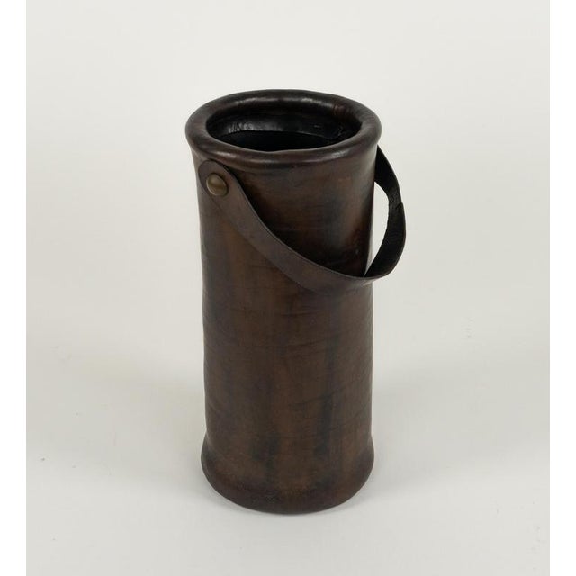 Midcentury beautiful umbrella stand or walking stick in leather and brass details with leather handle. Made in Italy in...