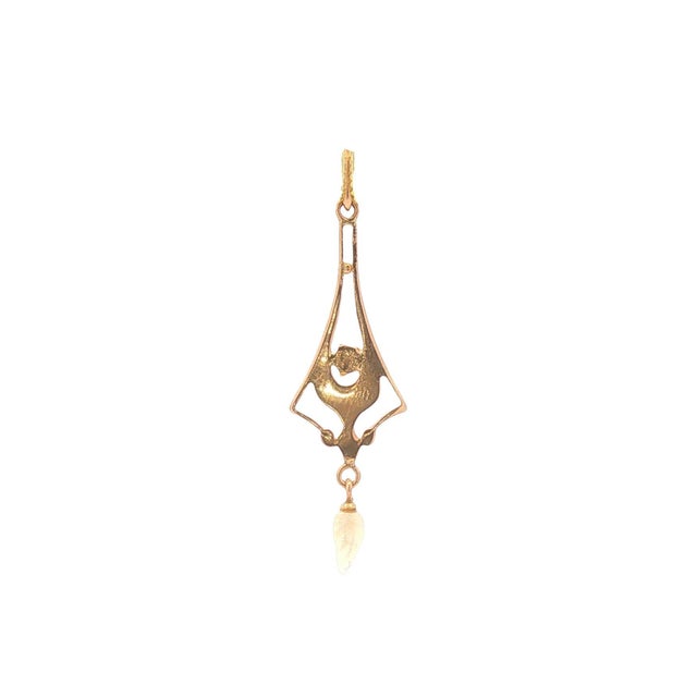 An Art Nouveau pendant crafted from 10k yellow gold. Features a round white diamond weighing 0.04 carats and black enamel....