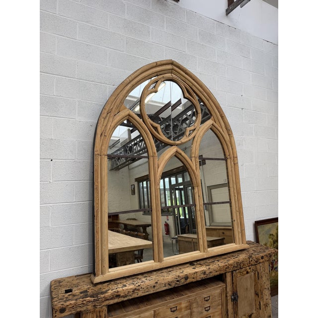 This massive wooden and metal mirror was crafted from an old chapel stained-glass window. Antique mirrors have replaced...