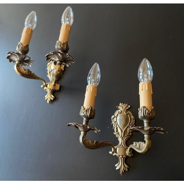 A magnificent pair of antique wall lights. italy, 20th century. the wall lights are made of brass with bronze elements -...