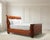 A luxurious and rare labeled Ralph Lauren "Villa America" queen-sized gondola sleigh bed, crafted out of mahogany and...