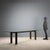 Large table with a rectangular glass top, beveled at the corners, and a wooden base with red marble legs. It shows some...