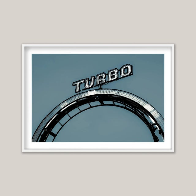 Turbo Blue presents a vibrant rendition of a vintage cast iron fairground sign, captured on Brighton’s iconic Palace Pier....