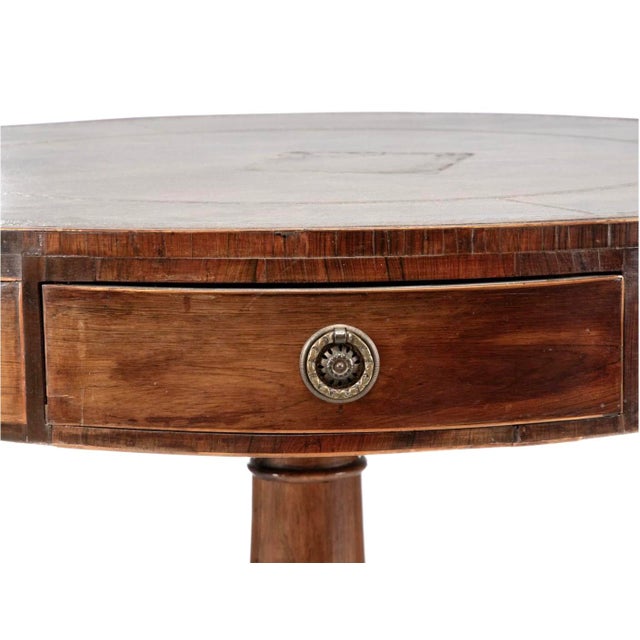 Early 19th Century English Regency Mahogany Drum Table. Table features leather inlay top, string inlay and four drawers....