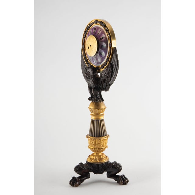 A finely cast 19th-century French Empire-style mantel clock in patinated and gilt bronze, notable for its sculptural...