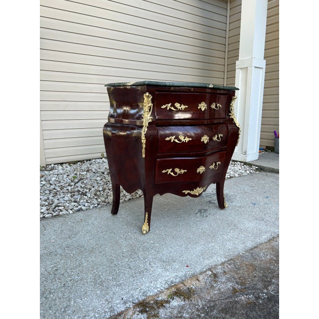 This is a late 18th century French Louis xv1 commode. Made of mahogany and dressed out with gold over bronze ornate....