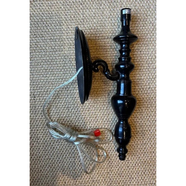 Vintage black iron wall sconce with beautiful detail. Plug-in utilizing one 40w bulb. 16"H x 4.5"W x 6.5"D.