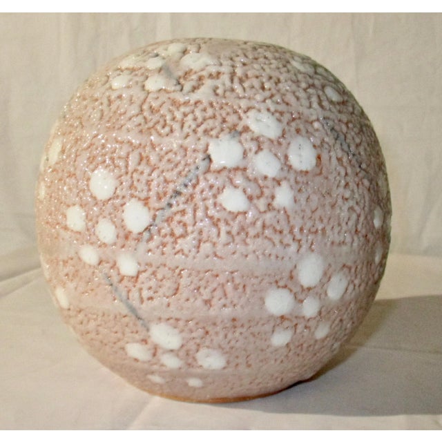 Beautiful globe in modern style. Shino glaze with pinhole on stoneware body. Blush pink with a traditional floral pattern...
