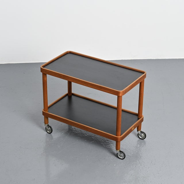 Rolling serving cart designed by Isamu Kenmochi and manufactured by Yamaguchi in Japan in the 1970s. The wooden structure...