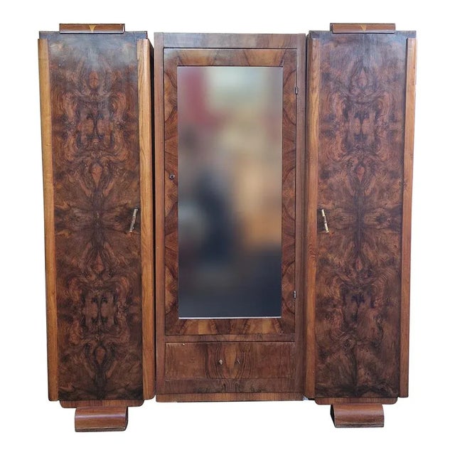 Art Deco walnut wardrobe with two side compartments with solid doors, a central compartment with a mirrored door and a...
