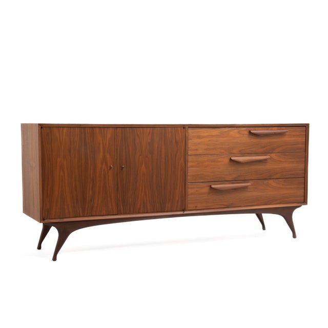 A sculptural Mid Century bedroom set consisting of four pieces, a low, six drawer dresser, a five drawer chest and two...