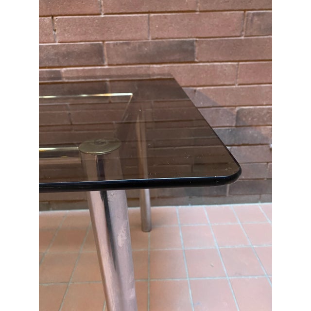 A beautiful sleek chrome and smoked glass Italian dining table that will easily accommodate six chairs. (As shown in...