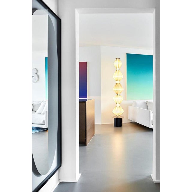 Oïphorique p pe floor lamp. Steel structure. Black lacquered canopy and black chrome trim disc. Light grey textil diffuser...