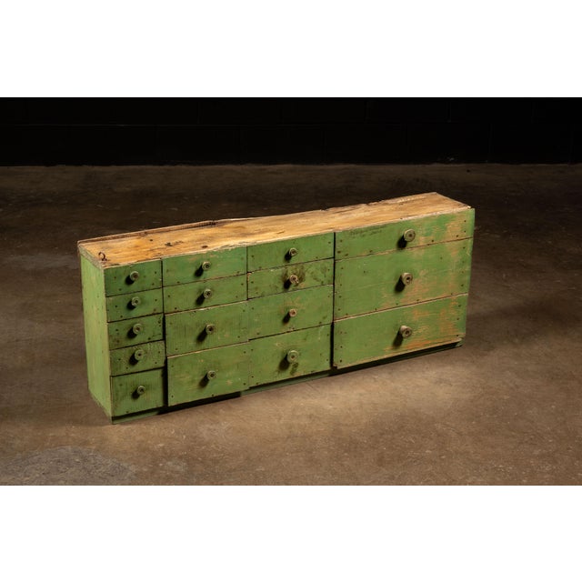 Industrial multi-drawer storage cabinet constructed from salvaged and repurposed wood shipping crates associated with...