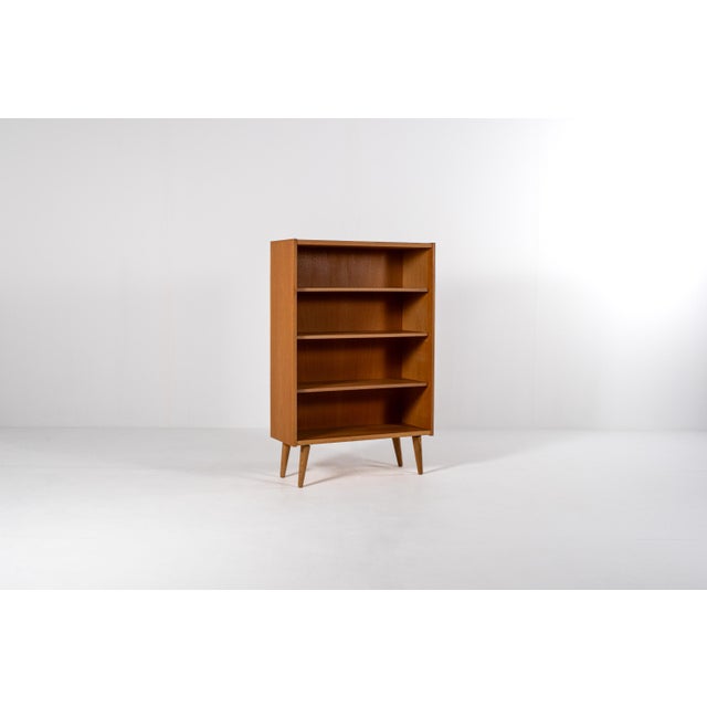 Beautiful Danish mid-century oak veneer bookcase from the 1960s. This elegant piece is made of warm honey-toned oak and...