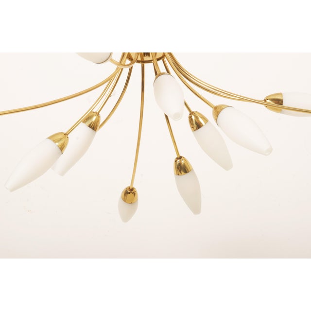 Brass frame with 12 arms and opaline glass shades each fitted with E14 sockets. Made in Vienna by Rupert Nikoll in the...