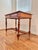 Antique French Louis XVI style writing table in warm-toned fruitwood, likely cherry. The table has a rectangular paneled...