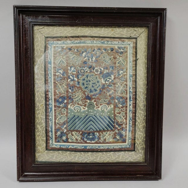 Circa 1800, Chinese silk panel of a peony surrounded by auspicious symbols above waves. This piece was part of a garment...