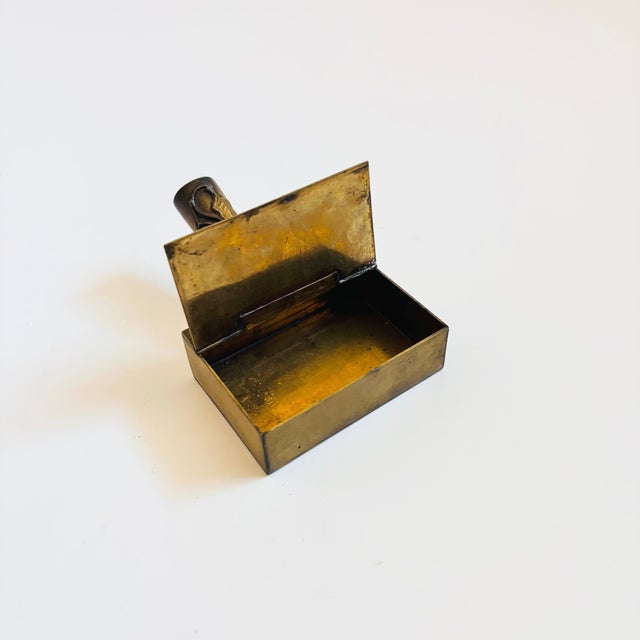 A small vintage cloisonne brass box with a handle. Features a hinged lid and decorated with an applied vine design and...