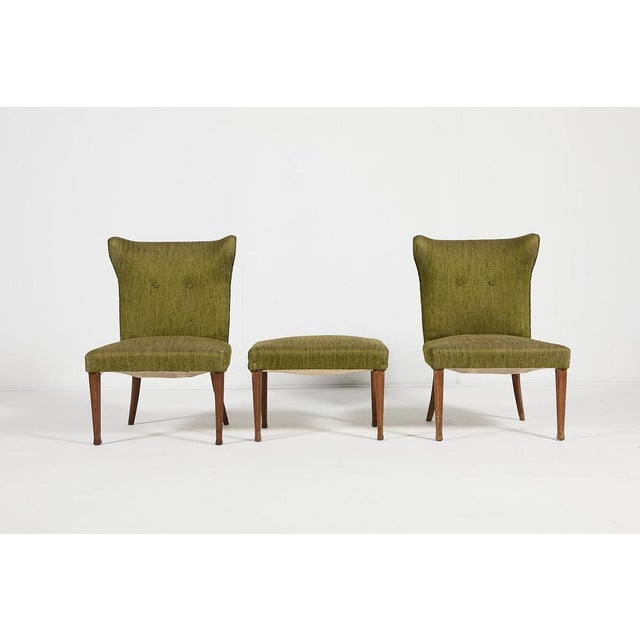 Modern Italian production set of 2 sculptural chairs with ottoman in moss green fabric upholstery on varnished wood legs...