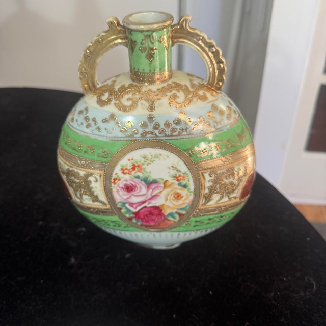 An exquisite antique French porcelain pilgrim flask-style canteen vase featuring a beautifully compressed globular form....