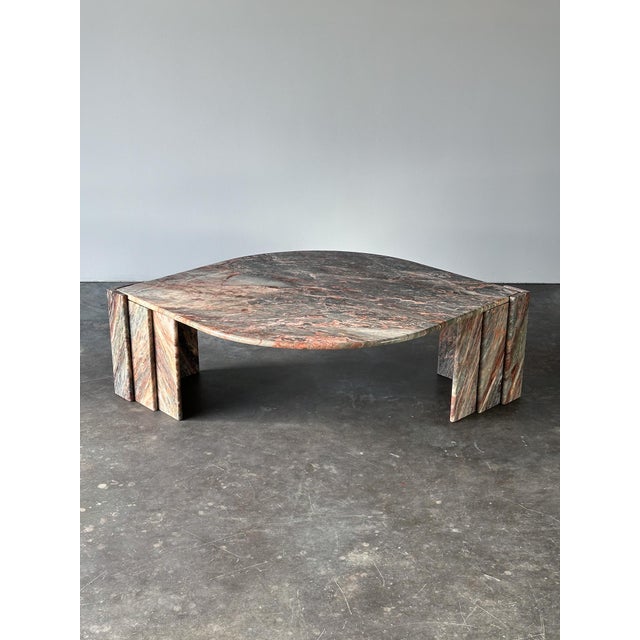 Cut from Fior di Pesco marble, this vintage coffee table carries a cool grey ground threaded with soft rose, ivory, and...