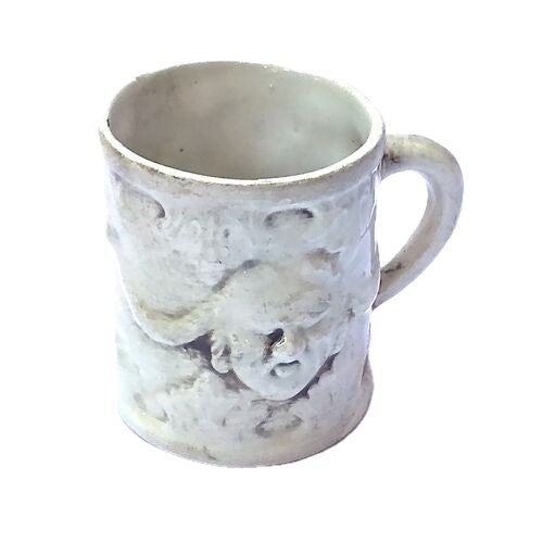 Antique ceramic creamer with a bas relief-style mythological face design and handle. Marked "Bassano" on the underside.