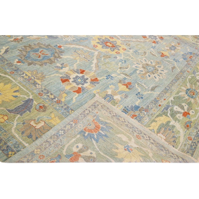 Beautiful modern Sultanabad hand-knotted wool rug with a blue field. This Sultanabad rug has a green frame and multicolor...
