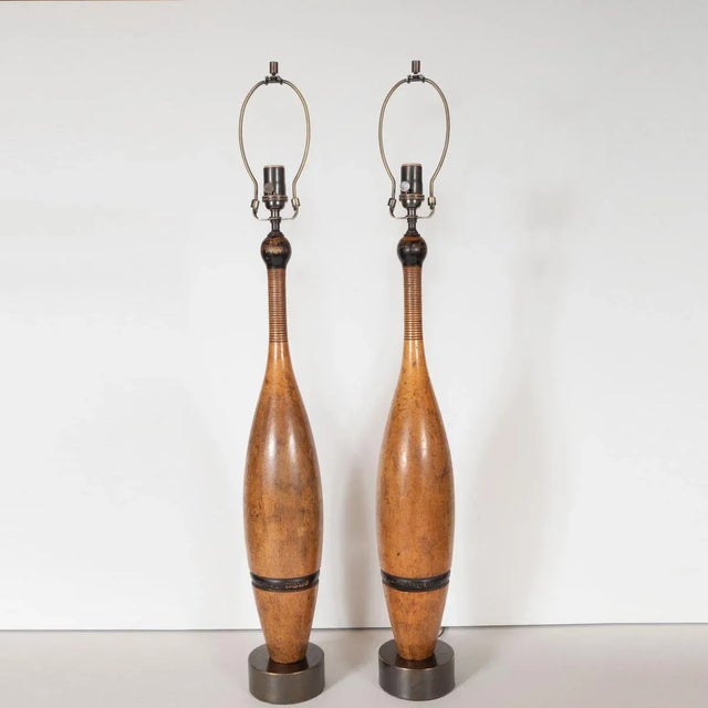 Pair of table lamps composed of retrofitted, turned and painted wood juggling pins with patinated brass hardware.