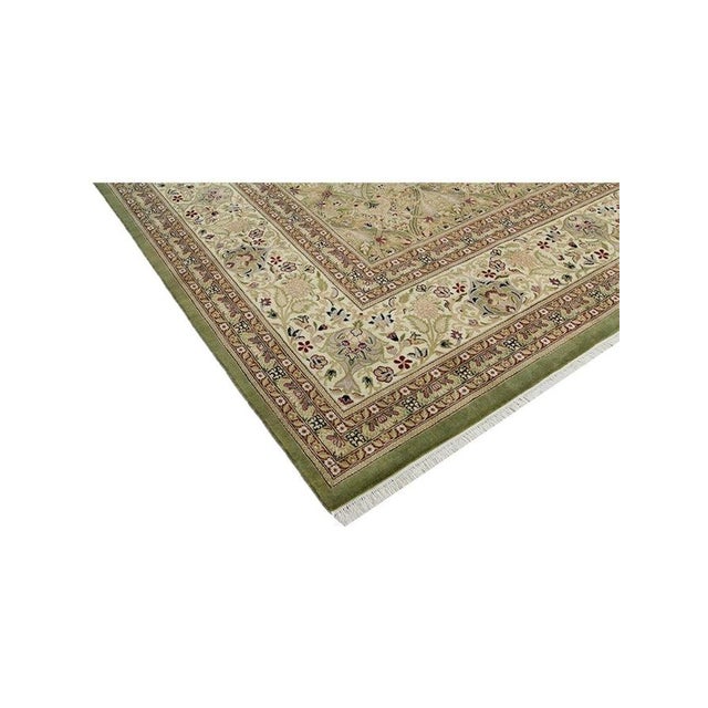 Enhance your living space with the elegant charm of this 12x16 Tabriz style rug from Pakistan. Its traditional design and...