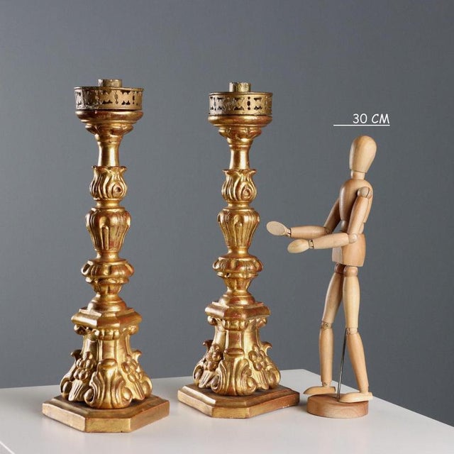 Pair of turned, carved, and gilded wooden torch holders. Wax tray in perforated, gilded iron. This piece is attributed to...
