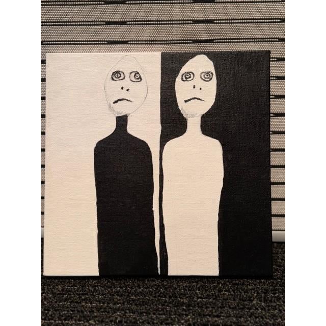 This black and white painting by Susan Cohen, of "Ying and Yang" depicts the state of mind on two sides of the fence in...