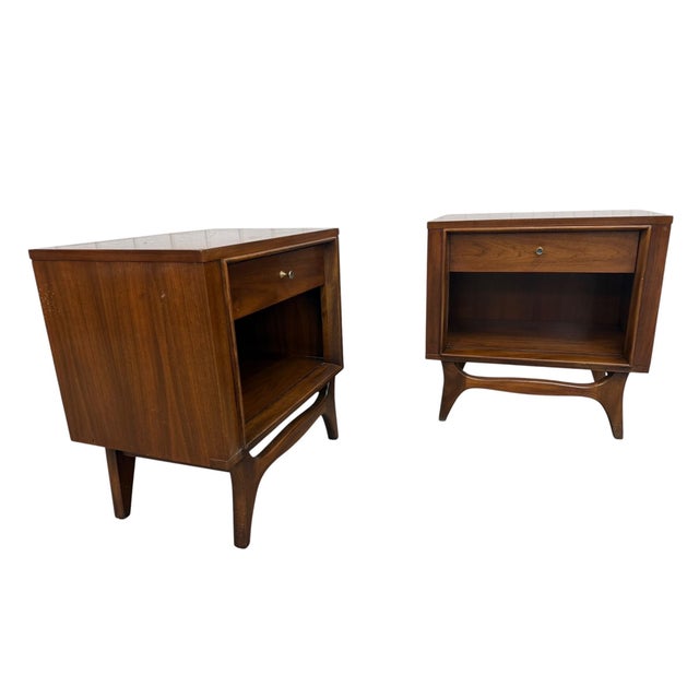 Stunning pair of Mid-Century Modern walnut nightstands from the highly desirable Insignia collection by Kent Coffey,...