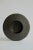 Wheel-thrown ceramic shallow vessel with a wide, sculptural rim, finished in a richly mottled, iron-toned glaze. The...