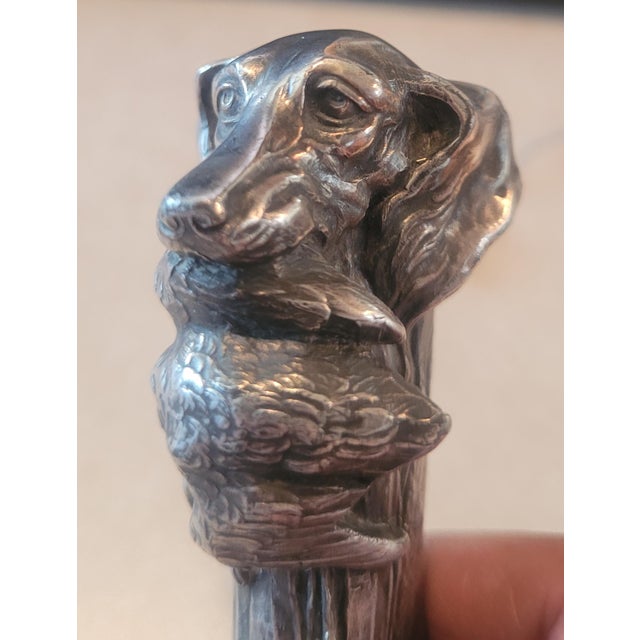 Antique circa 1900 silver-plated figural cigar cutter featuring a wonderfully detailed hunting / retriever dog carrying a...