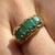 A luminous 1970s emerald ring crafted in solid 14K yellow gold and set with four earth-mined emeralds arranged in a unique...