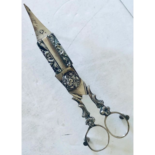 This English Silver Plated Candlewick Scissor is positioned up on three ball feet and is a handy tool to have on your...