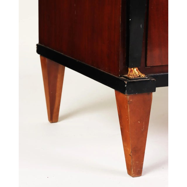 A French Empire Neoclassical style mahogany chest of drawers with ormolu mounts, late nineteenth century. This three...