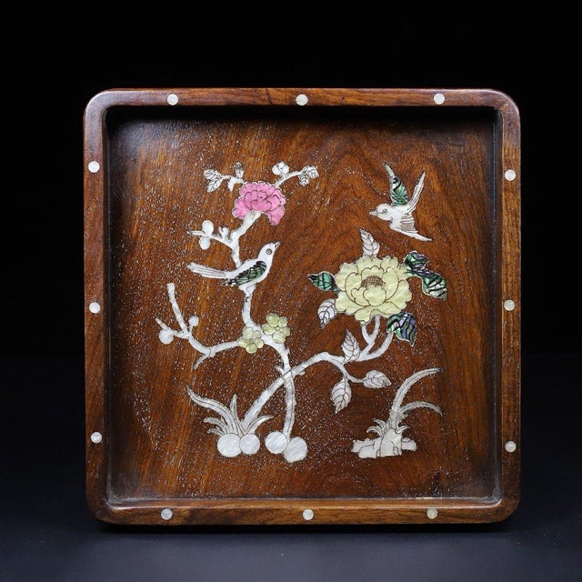 This is an exquisite square wooden tray featuring intricate mother-of-pearl (nacre) inlay work. Crafted from a richly...