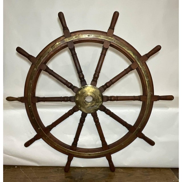 Very large ships wheel with polished brass outer ring and large brass hub. This is a twelve spoke giant of a wheel. Great...