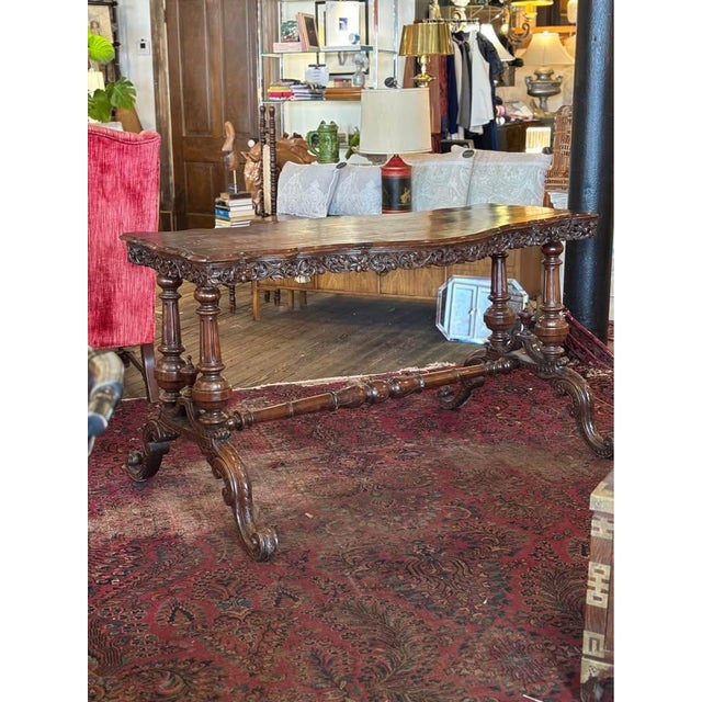 Gorgeous Victorian library table with turned stretcher bar, carved skirting, finial embellishment. Table top has seen some...