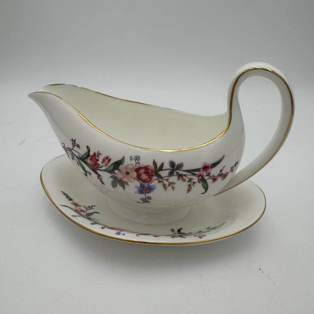 Wedgwoods Devon Sprays is a graceful dinnerware pattern accented with blue & pink flowers, long stems, and leaves. With...