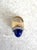 A wonderfully dramatic and vibrant cocktail ring featuring a blue lapis, surrounded by sparkling rhinestones set in a...